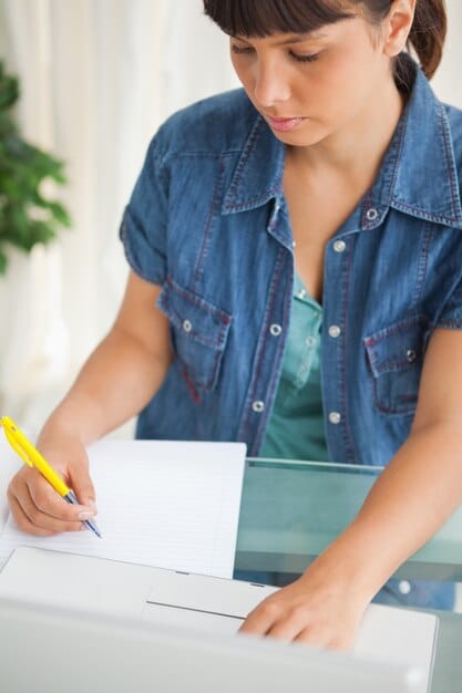 A person filling out a form with the header 