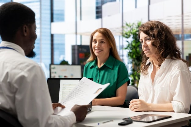 A close-up shot of a person's hand pointing at a health insurance document while discussing it with a health insurance broker face to face in a friendly environment.