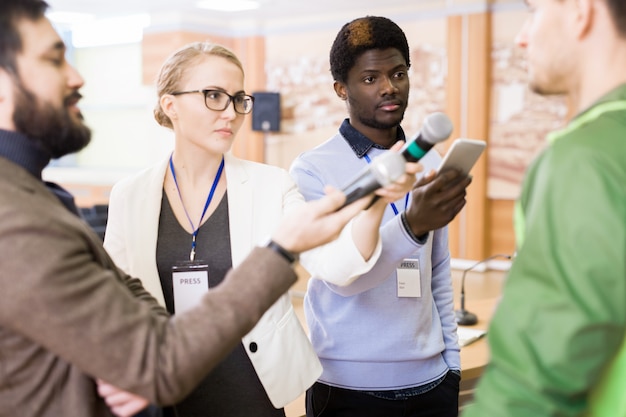 A diverse group of professionals networking at a conference, highlighting the community and potential benefits of professional associations.