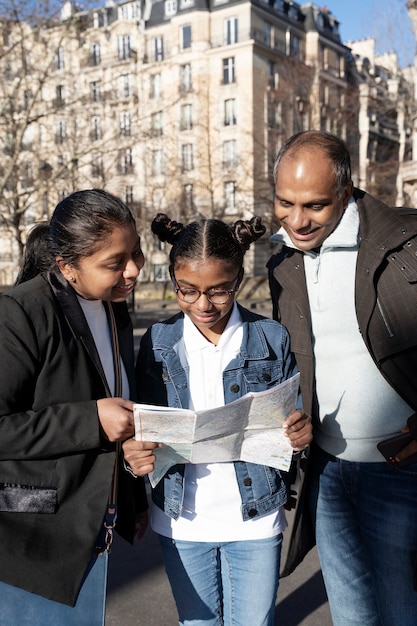 A diverse group of part-time workers in casual attire, smiling and looking towards a brightly lit cityscape. One of them is holding a document related to healthcare enrollment.