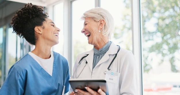 A doctor smiling and consulting with a patient, showing the importance of personalized care and affordable healthcare.