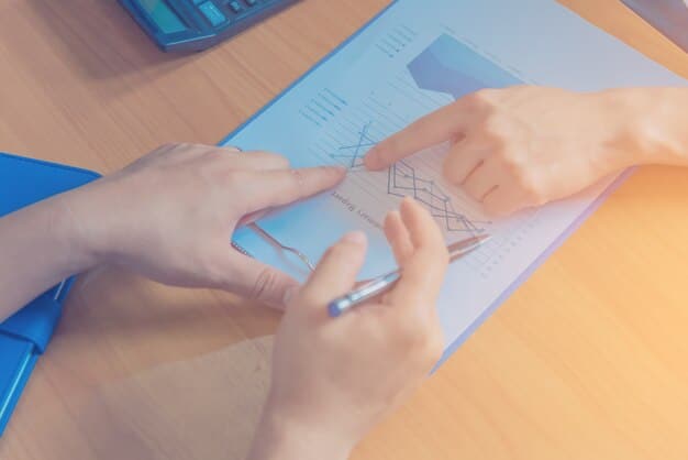 Close-up of a person's hand pointing to a specific health plan on a comparison chart, with other plan options blurred in the background, emphasizing the decision-making process.