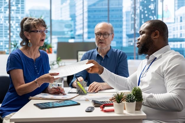 A diverse group of people discussing health insurance options with an insurance agent in a modern office setting.
