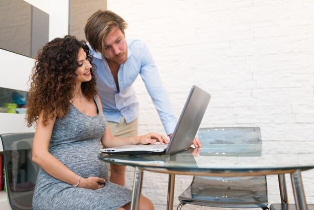 A healthcare professional explaining health insurance options to a pregnant couple in a well-lit office.