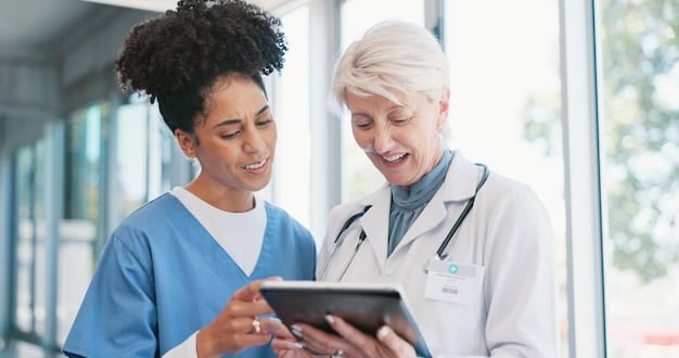 A healthcare professional assisting a patient with understanding her insurance coverage options using a digital tablet.