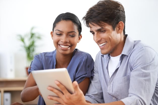 A diverse group of people smiling and pointing at a tablet displaying a health insurance marketplace website, representing the accessibility and options available.