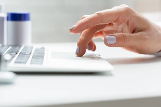 A close-up of a person reviewing updated Medicare guidelines on a laptop screen, highlighting key areas of change for the 2025 Medicare Advantage plans. The background is a home office setting.