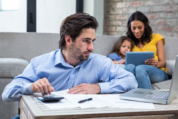 A person using an online tax credit calculator on a laptop, entering income and family size information.