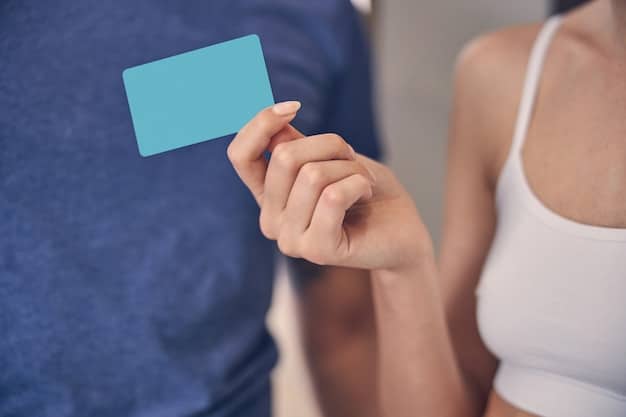 A close-up of a health insurance card being held by a person, emphasizing the importance of maintaining coverage. The background is blurred, focusing attention on the card.
