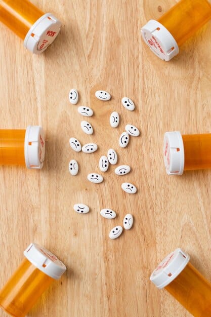 A close-up shot of prescription bottles with various health insurance cards scattered around, focusing on the importance of understanding drug coverage.