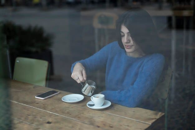 A person sitting calmly at a table after a meal, perhaps with a half-empty teacup, gazing thoughtfully out a window, signifying quiet reflection.