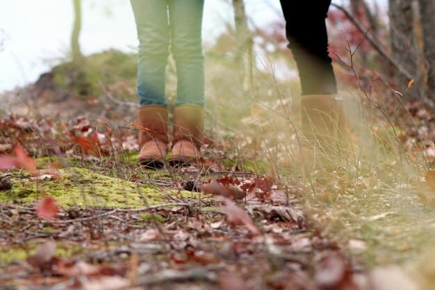 A close-up shot of a person's feet in comfortable walking shoes, stepping gently on a mossy path in a forest, emphasizing the connection to the ground.