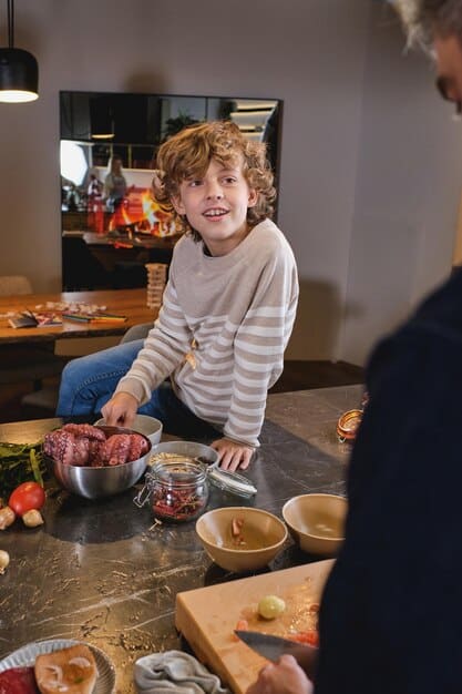 A child and parent together, in a brightly lit kitchen, collaboratively preparing a meal with a focus on shared learning and calm interaction, symbolizing teamwork and clear communication.