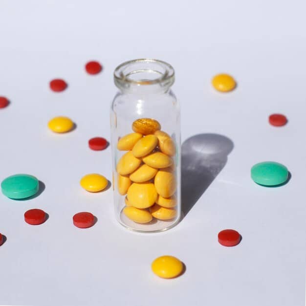 A close-up shot of various colorful vitamin tablets and capsules spilling from a small white bottle onto a clean, light-colored surface, suggesting daily supplementation.