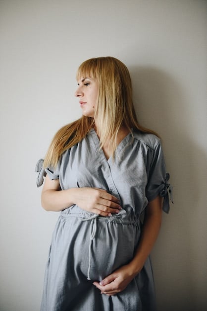 A pregnant woman gently holding her belly, looking serene and healthy, with soft natural light highlighting her profile, suggesting well-being during pregnancy.