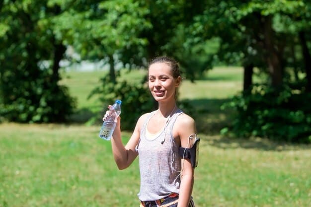 A person's hand holding a reusable water bottle during a morning jog in a sunny park, emphasizing active lifestyle and sustainable hydration.