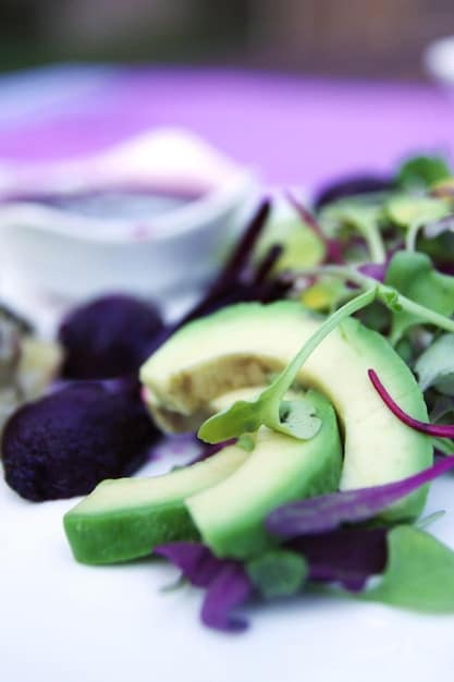 A close-up shot of colorful fruits and vegetables, specifically highlighting green leafy vegetables, berries, and citrus fruits, suggesting a healthy, vibrant diet.