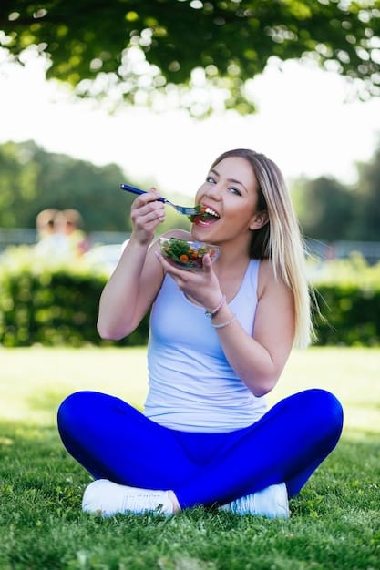 A person smiling while enjoying a balanced meal outdoors, demonstrating tranquility and health, with a vibrant green background.