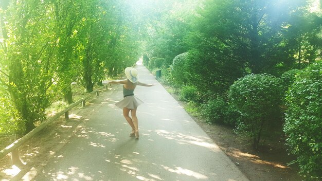 A person running confidently outdoors on a trail, with a clear blue sky and lush greenery, depicting freedom and mental clarity.