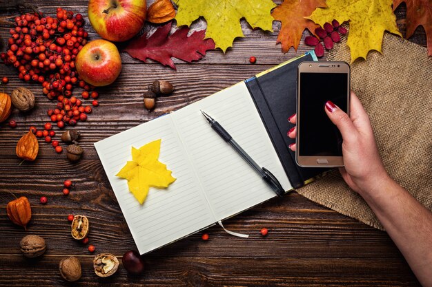 A person diligently writing in a planner, surrounded by sticky notes with self-care reminders and a small plant, symbolizing intentional planning and consistent self-care integration.