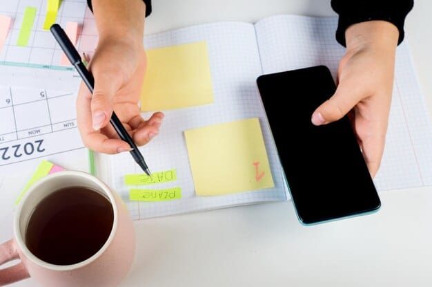 A person using a planner and sticky notes, meticulously organizing tasks, symbolizing systematic planning and review.