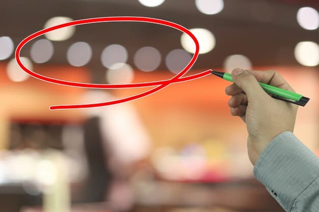 A person's hand drawing a clear red line on a white board, illustrating the concept of setting a firm boundary.