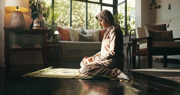 A person meditating in a quiet, sunlit room. The room is decorated with plants and soft, calming colors. The person is sitting comfortably on a cushion with their eyes closed.