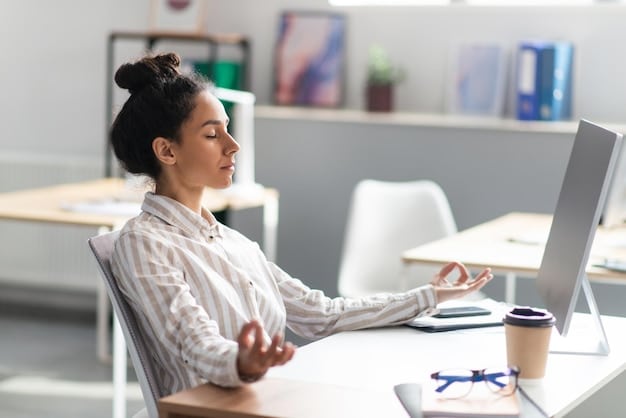 A person practicing deep breathing exercises at their desk during a workday. The image should show a calm and focused individual amidst a busy office environment, emphasizing stress reduction and improved mental well-being.