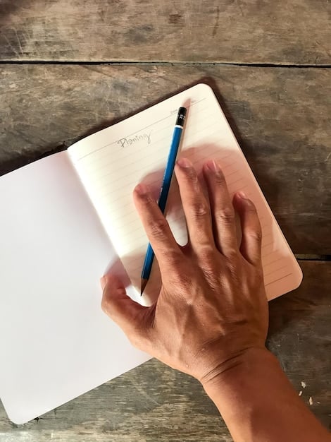 A close-up shot of a person's hands writing in a journal with a pen. The journal is open, and the writing is visible but not legible. The background is blurred, with soft natural light. Relates to the techniques of mindful journaling.