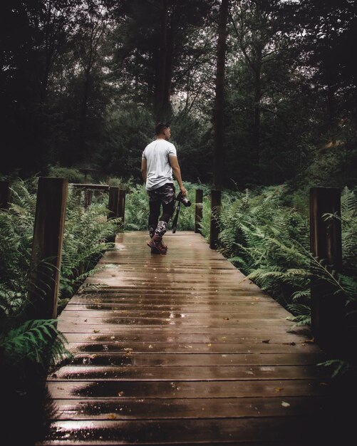 A person practicing mindful walking in a peaceful forest setting, focusing on their steps and the surrounding nature. This symbolizes the connection between physical activity, mindfulness, and improved cognitive function by understanding insider knowledge: the surprising link between mindfulness and improved memory retention from a natural enviornment.