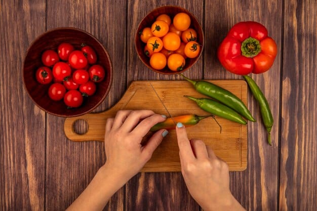 A close-up overhead shot of a person's hands chopping colorful vegetables, such as bell peppers, carrots, and broccoli, on a wooden cutting board. A chef’s knife is visible, along with other prepped ingredients in small bowls around the cutting board, emphasizing the preparation stage of Meal Prep Like a Pro: Save Time and Eat Healthy All Week Long.