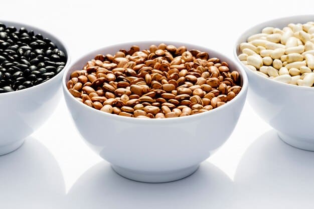 A close-up shot of various legumes (lentils, chickpeas, black beans) in separate bowls, illustrating their texture and color. The photo emphasizes the high protein content of these legumes and is relevant to The Ultimate Guide to Plant-Based Protein Sources in 2025.