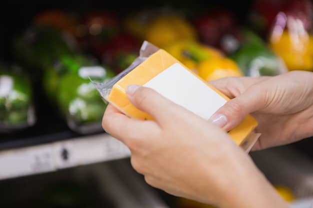 A person's hands holding a nutrition label on a processed food item. The label is magnified to highlight ingredients like high fructose corn syrup, sucrose, and dextrose. The background shows shelves stocked with various food products in a supermarket. This visual emphasizes the importance of reading labels to identify hidden sugars when figuring out How to Cut Sugar Intake by 50% in 30 Days.
