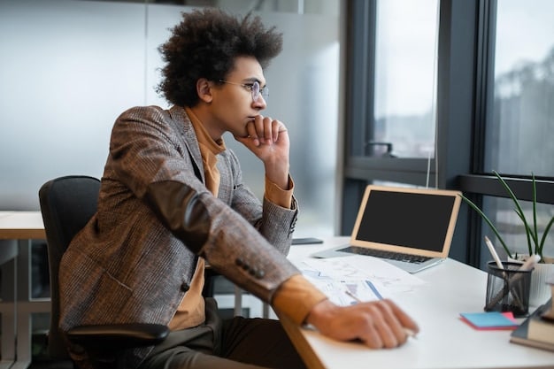 An individual sitting at a desk in a busy office, closing their eyes and practicing deep breathing exercises. Their posture is relaxed, and a serene expression is on their face, demonstrating the practical application of mindfulness for immediate stress relief, linking back to 