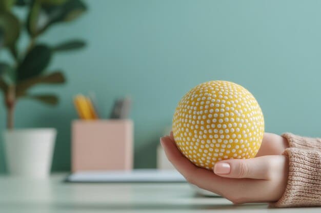 A close-up shot of hands gently holding a stress ball at a desk in an office, exemplifying a simple yet effective mindfulness technique for quick stress relief during work hours, directly related to 