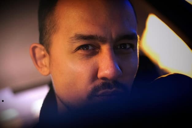 A close-up shot of a person's face, looking tired and slightly downcast. The lighting is soft and diffused, emphasizing the person's weary expression. The backdrop is blurred, keeping the focus on the face. The image represents the fatigue and low energy associated Understanding Seasonal Affective Disorder (SAD): Symptoms, Treatments, and Coping Strategies for Winter 2025.