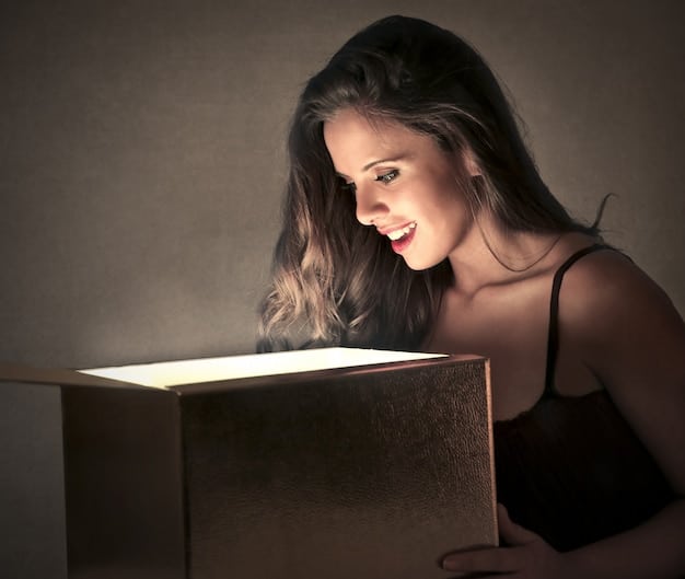 A person sitting in front of a light therapy box, reading a book. The light box is positioned slightly above eye level, emitting a bright, white light. The person appears relaxed and comfortable. The image represents the Understanding Seasonal Affective Disorder (SAD): Symptoms, Treatments, and Coping Strategies for Winter 2025