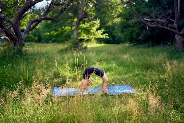 A person practicing yoga or stretching outdoors in a peaceful and natural setting, emphasizing relaxation and stress relief, and also showing The Financial Impact of Burnout: How Prioritizing Mental Wellness Can Save You Money