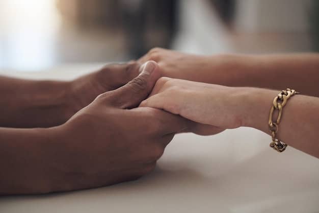 A close-up of two hands clasped together, symbolizing support and empathy in a therapy session. The image conveys a sense of trust and connection, emphasizing the therapeutic alliance and The Benefits of Therapy: How Talking to a Professional Can Improve Your Mental Health