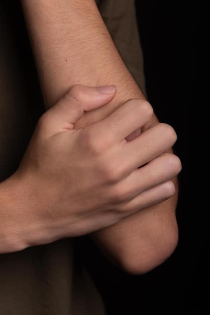 A close-up shot of a person's hands gently placed on their knees. The background is blurred, focusing attention on the hands, symbolizing mindfulness and presence. The image relates to the practice of How to Increase Your Daily Mindfulness by 15% in Just 2 Weeks.