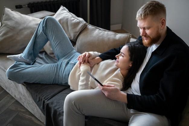 A couple sitting comfortably on a couch, facing each other, engaged in a heartfelt and understanding conversation, symbolizing The Art of Effective Communication: Improve Your Relationships and Achieve Your Goals in a personal context. The room is warmly lit with soft, inviting colors.