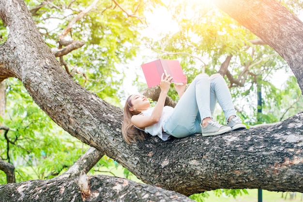 A person reading a book under a tree, symbolizing a love for learning and continuous personal growth.