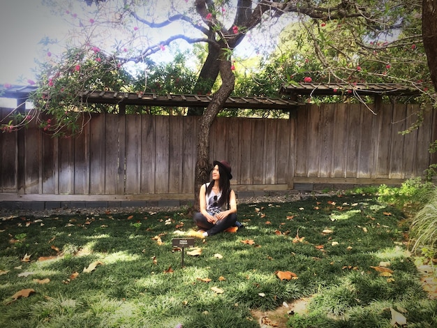 A person meditating in a serene setting, such as a park or quiet room, with their phone turned off beside them. This image represents the importance of disconnecting from technology and practicing mindfulness to improve focus and reduce distractions.